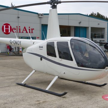 Beautiful New Robinson R44 Ravel I helicopter with white and grey paint scheme, plush interior and impact resistant windshield