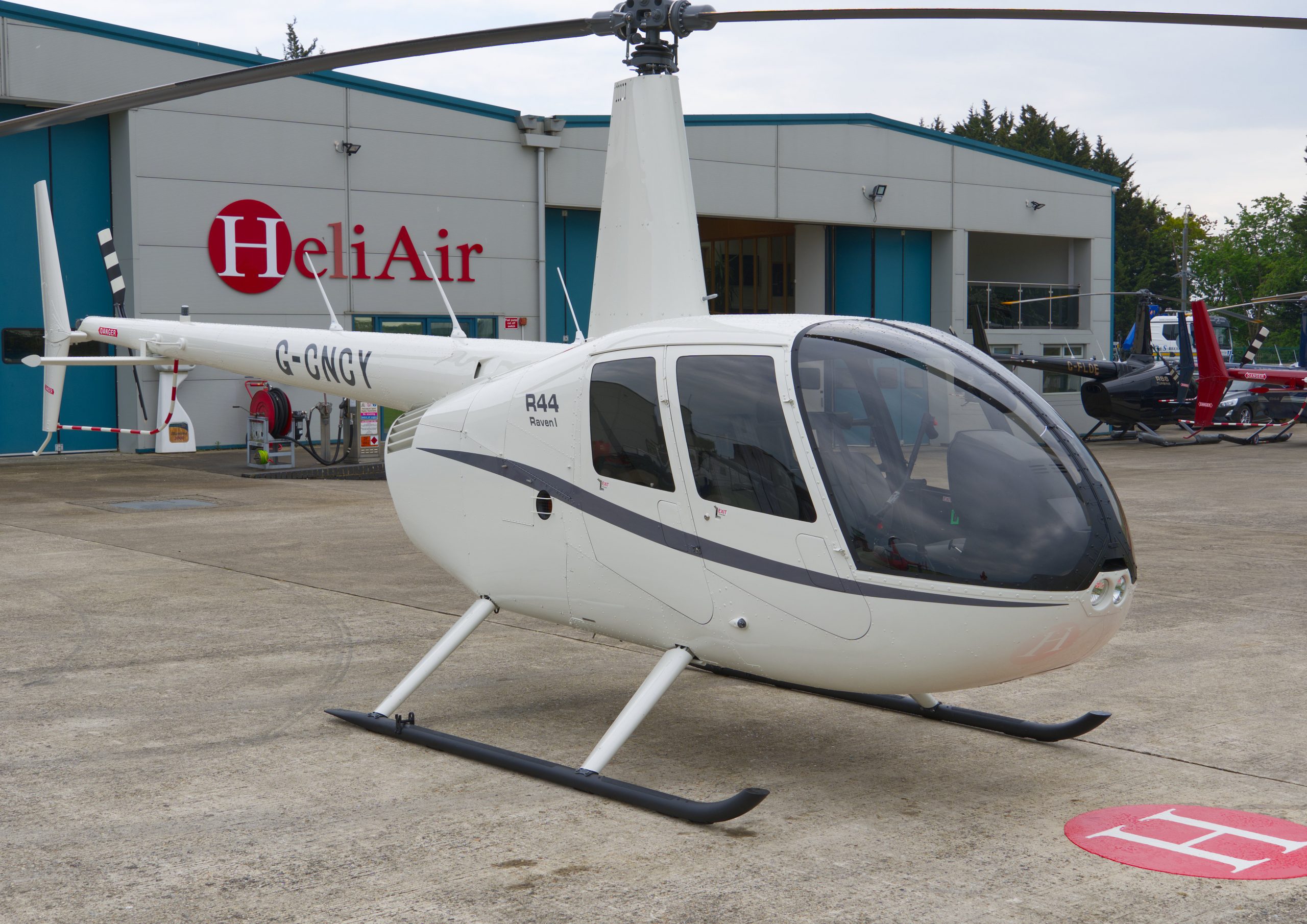 Beautiful New Robinson R44 Raven I helicopter with white and grey paint scheme, plush interior and impact resistant windshield