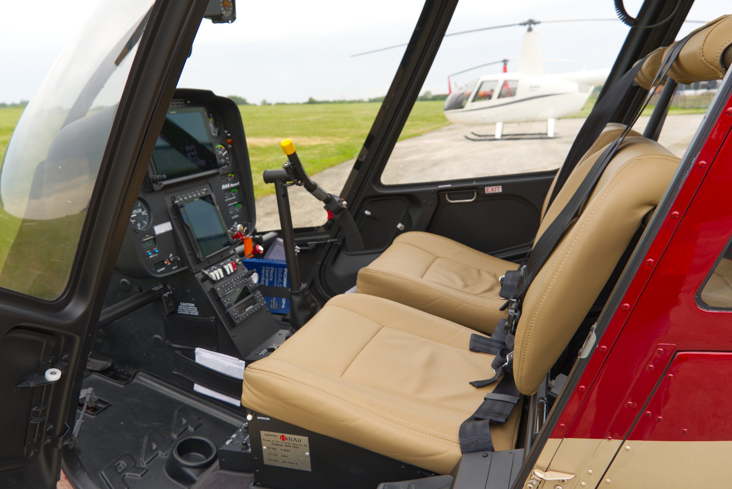 Beautiful New Robinson R44 Ravel II helicopter with red and gold paint scheme, plush interior, and full avonics and extras within the specification.