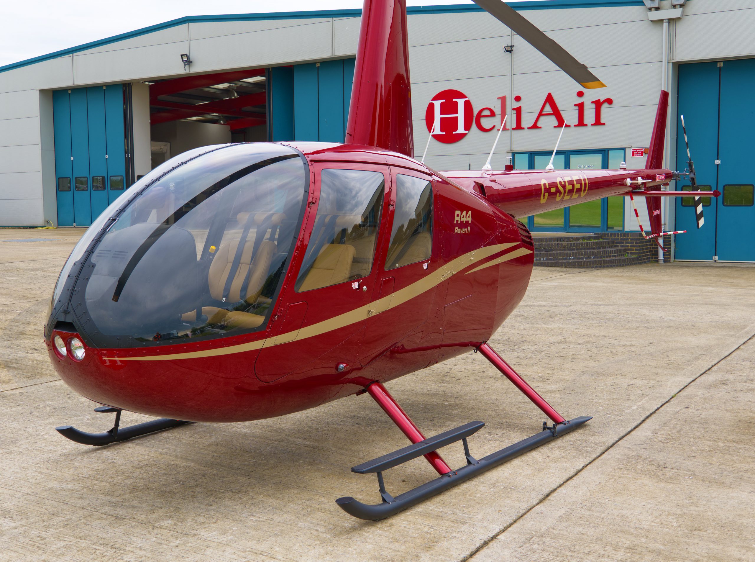 Beautiful New Robinson R44 Ravel II helicopter with red and gold paint scheme, plush interior, and full avonics and extras within the specification.